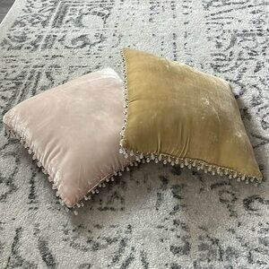 Two small handmade plush pillows with beads